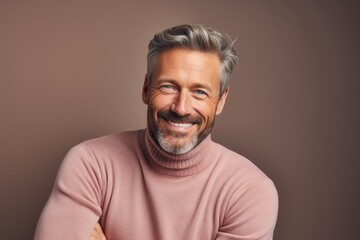Fototapeta premium Portrait of a cheerful man in his 40s wearing a classic turtleneck sweater against a pastel brown background. AI Generation