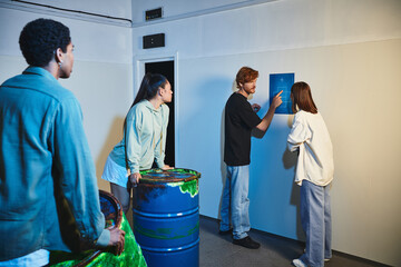 redhead man showing clue to his interracial friends during quest in escape room, mystery solving