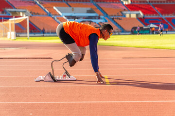 Asian para-athlete runner prosthetic leg on the track alone outside on a stadium track Paralympic running concept.