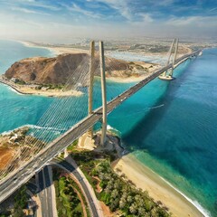 Aerial coastal landscape featuring suspension bridge