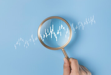 Magnifier focus on stock or forex market graph trading. Discovery trend grow up gain and profits....