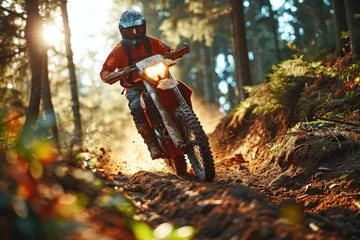 Foto op Plexiglas Motocross rider on the race in the forest at sunset. Motocross. Enduro. Extreme sport concept. © John Martin