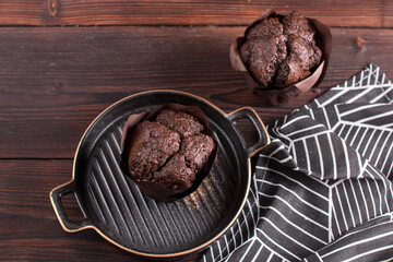 Making muffin cupcake in the kitchen. Chocolate pastries on a plate