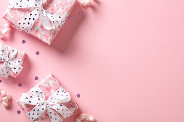 Valentine's day gifts with hearts on pastel pink background