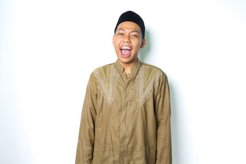 excited asian muslim man wearing islamic dress screaming at camera isolated in white background