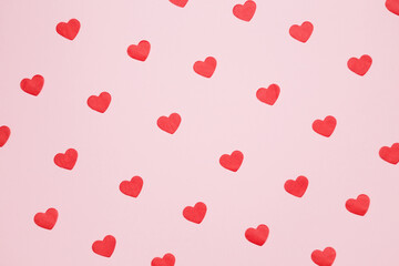 Paper hearts on a pink background for Valentine's Day, happy anniversary. Top view