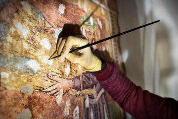 Restorer Painter Female Hand Working With Extreme Care and Patience  on an Ancient Fresco in...