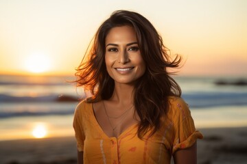 Portrait of a glad indian woman in her 30s dressed in a casual t-shirt against a vibrant beach sunset background. AI Generation