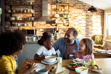 Happy diverse family enjoying breakfast together at home - obrazy, fototapety, plakaty