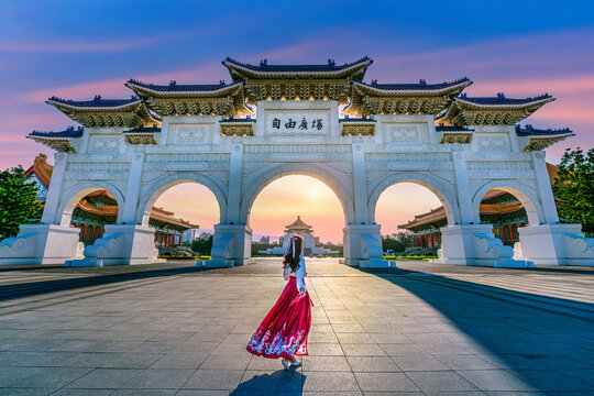 Asian woman in chinese dress traditional walking in Archway of Chiang Kai Shek Memorial Hall in Taipei, Taiwan. Translation: "Liberty Square".