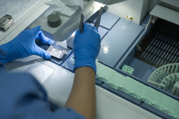 A medical scientist prepares a pathological specimen for a pathologist to diagnose.