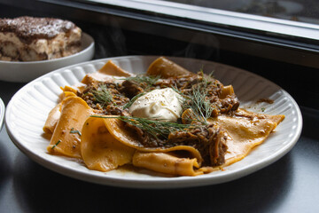 Slowly Braised Lamb Ragu on a white plate