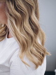 Fototapeta premium Blonde girl in a white T-shirt with hairstyle