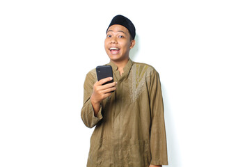 funny asian muslim man using smartphone looking at camera isolated on white background