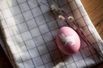 Easter serving. bunny egg and willow branches on textile napkin