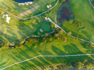 Aerial view of beautiful green golf field fairway and putting green, Top down image for sport background and travel nature background, Amazing  green nature view
