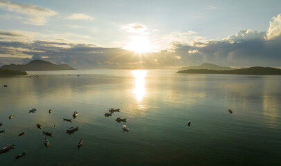 Amazing sunset or sunrise sky over sea landscape,Beautiful colorful light of nature with boats in the sea,Drone camera shot,Top down nature view seascape