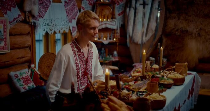 hospitable Slavic man meeting guests in ancient house, portrait of blonde young man, 4K, Prores