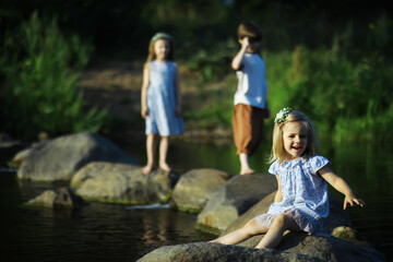 Children walk in the summer in nature. Child on a sunny spring morning in the park. Traveling with children.