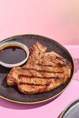 Grilled beef steak with Demi-Glace sauce; a high-end gastronomic delight against a pastel floral backdrop