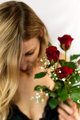 beautiful blond woman looking down, red roses in front of her, sadness, valentines day, 