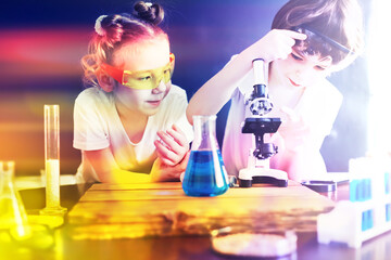 Background with highlights of children of scientists. A boy and a girl are experimenting in the...