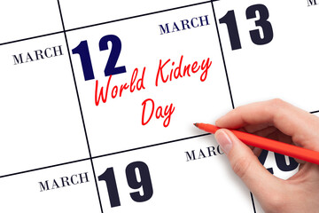 March 12. Hand writing text World Kidney Day on calendar date. Save the date.