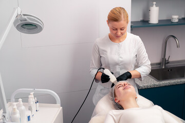 a cosmetologist will perform a face-lifting cosmetic procedure on a client in a beauty salon