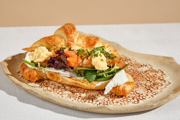 Stylish Croissant with Salmon and Omelet in Retro Sunlit Setting