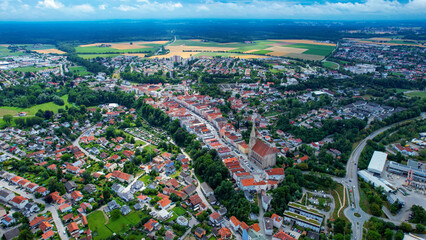 Aerial around the old town of the city Neuoetting in Bavaria on a cloudy day in summer