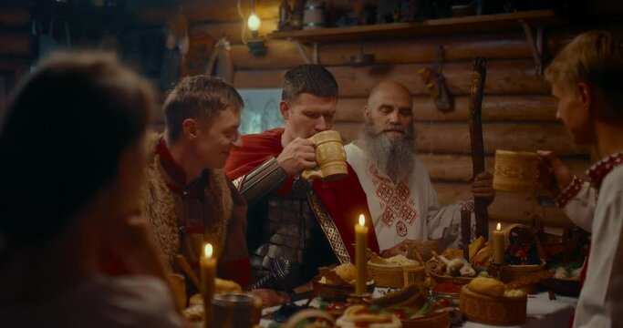 gathering of medieval Slavic village dwellers, men in historical suits dinning, 4K, Prores