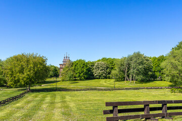 Obraz premium Spring green landscape with wooden temple and fence.