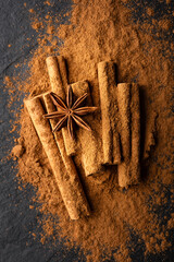 Cinnamon sticks and cinnamon powder with anise star close up. Studio macro shot. Food photography
