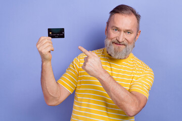 Portrait of nice person indicate finger arm hold plastic debit card offer ad isolated on purple color background