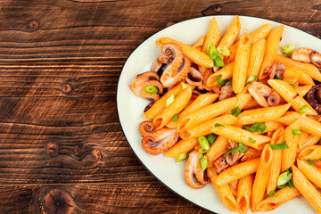 Pasta, macaroni with octopus pieces.