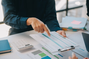Business team working with new startup project plan and discussion information for financial strategy with laptop and digital tablet in a modern business lounge.