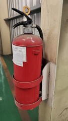 fire extinguisher hang on the wall at factory ready to use. 