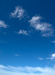 Naklejka na ściany i meble White fluffy clouds in the blue sky.
