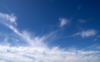 Naklejka na ściany i meble White fluffy clouds in the blue sky.