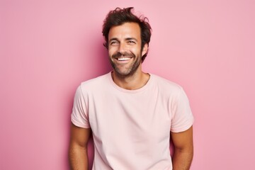 Portrait of a happy man in his 30s sporting a vintage band t-shirt against a pastel or soft colors...