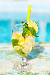 Glasses of homemade lemonade on a rustic wooden background