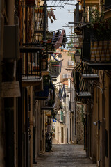 Cefalu, Sicily, Italy A shadowy alley in the historic center with balconoies.