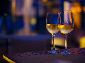 Two glasses of the white wine in the night