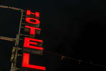 Palermo, Sicily, Italy  A red Hotel sign on Via Roma at night.
