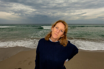 Palermo, Sicily, Italy A woman tourist on the beach in the winter off season.