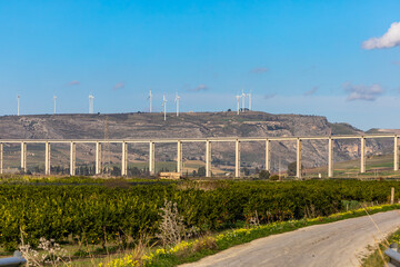 Fototapeta na wymiar Sciacca, Sicily, Italy The SS115 bridge with wind turbines in the distance.