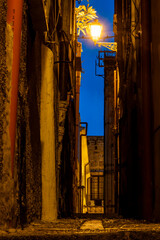 Fototapeta premium Palermo, Sicily, Italy A back alley at night in the town center.