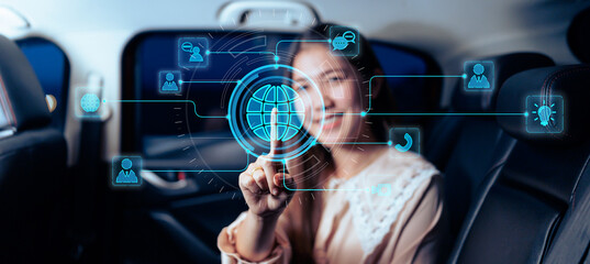 Asian business women in car transport using internet technology, connectivity staying connected to people wireless internet connection, while traveling commuting in automotive vehicle passenger.