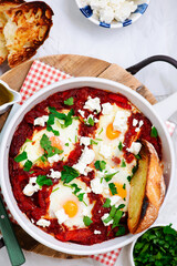 Shakshukka with feta and bread.traditional moroccan dish. selective focus. hugge style
