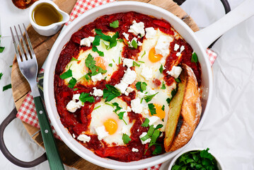 Shakshukka with feta and bread.traditional moroccan dish. selective focus. hugge style